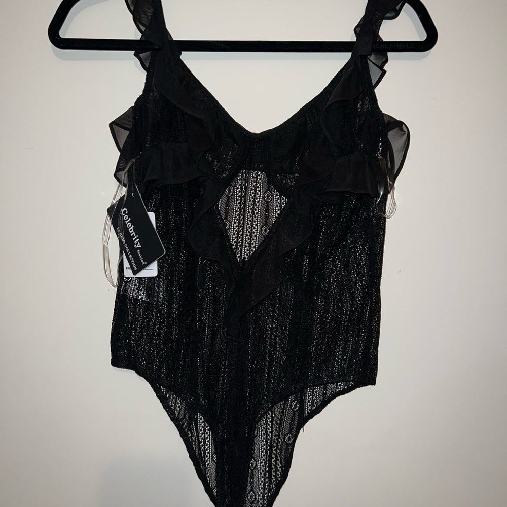 New See thru bodysuit mesh material. Medium size black with ruffles strapless